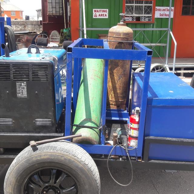 Mobile welding trailer with welder and gas cylinders